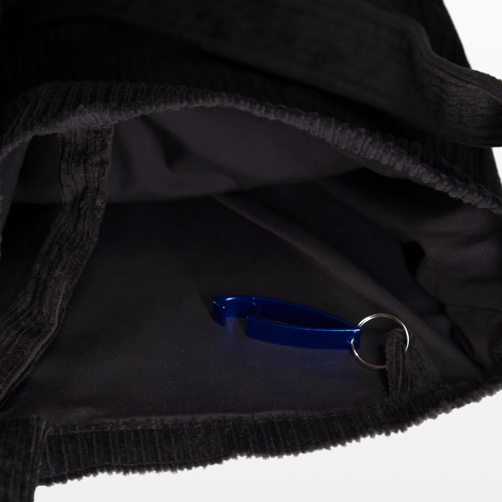 Inside the BIRGER sling bag, showing the lining and bottle opener