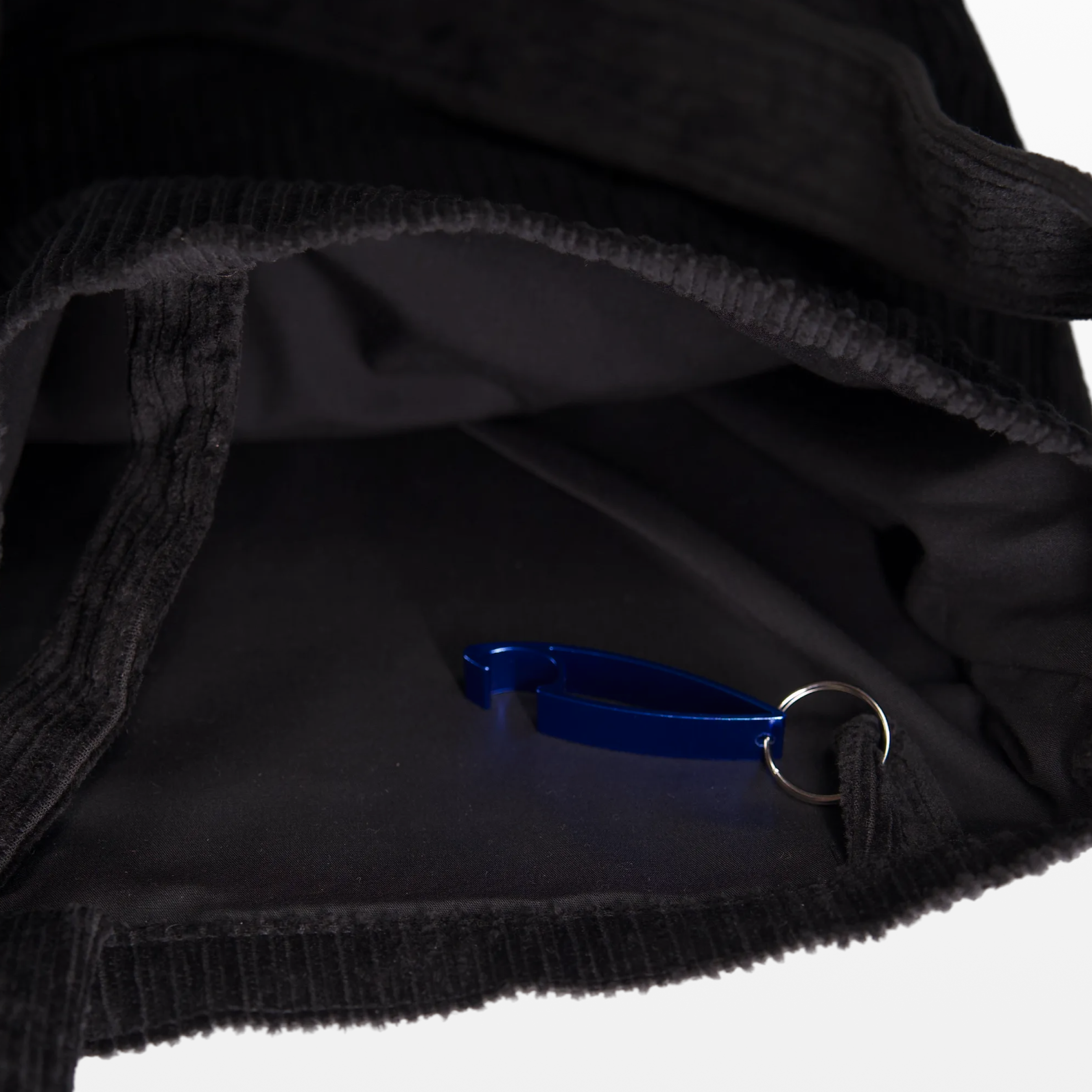 Inside the BIRGER sling bag, showing the lining and bottle opener