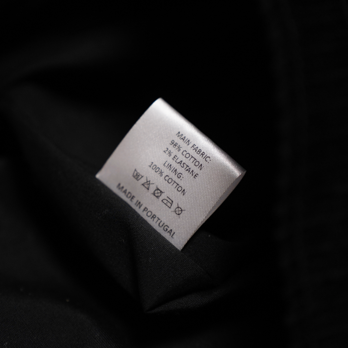 Care label showing fabric composition and made in Portugal