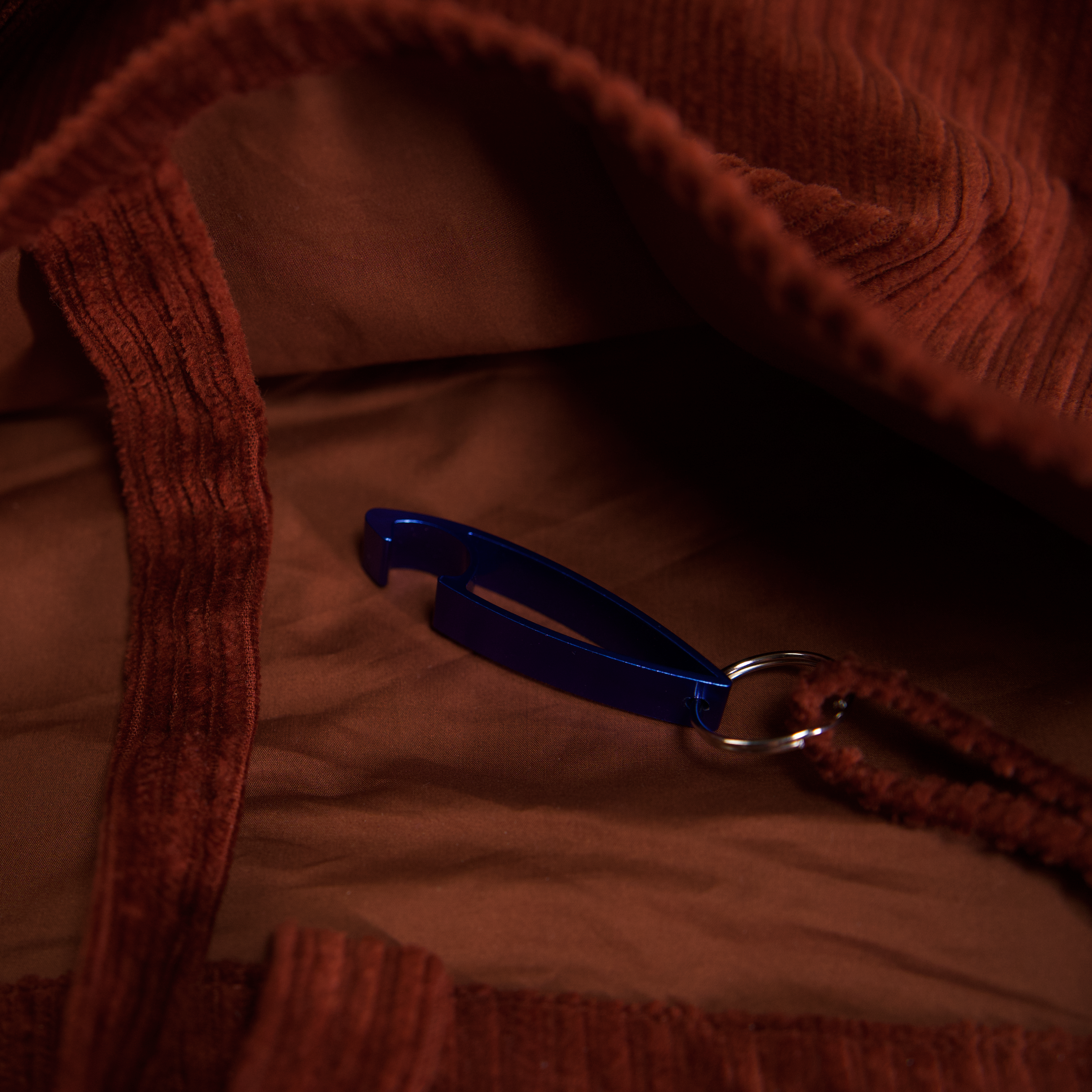 Inside the BIRGER sling bag, showing the lining and bottle opener