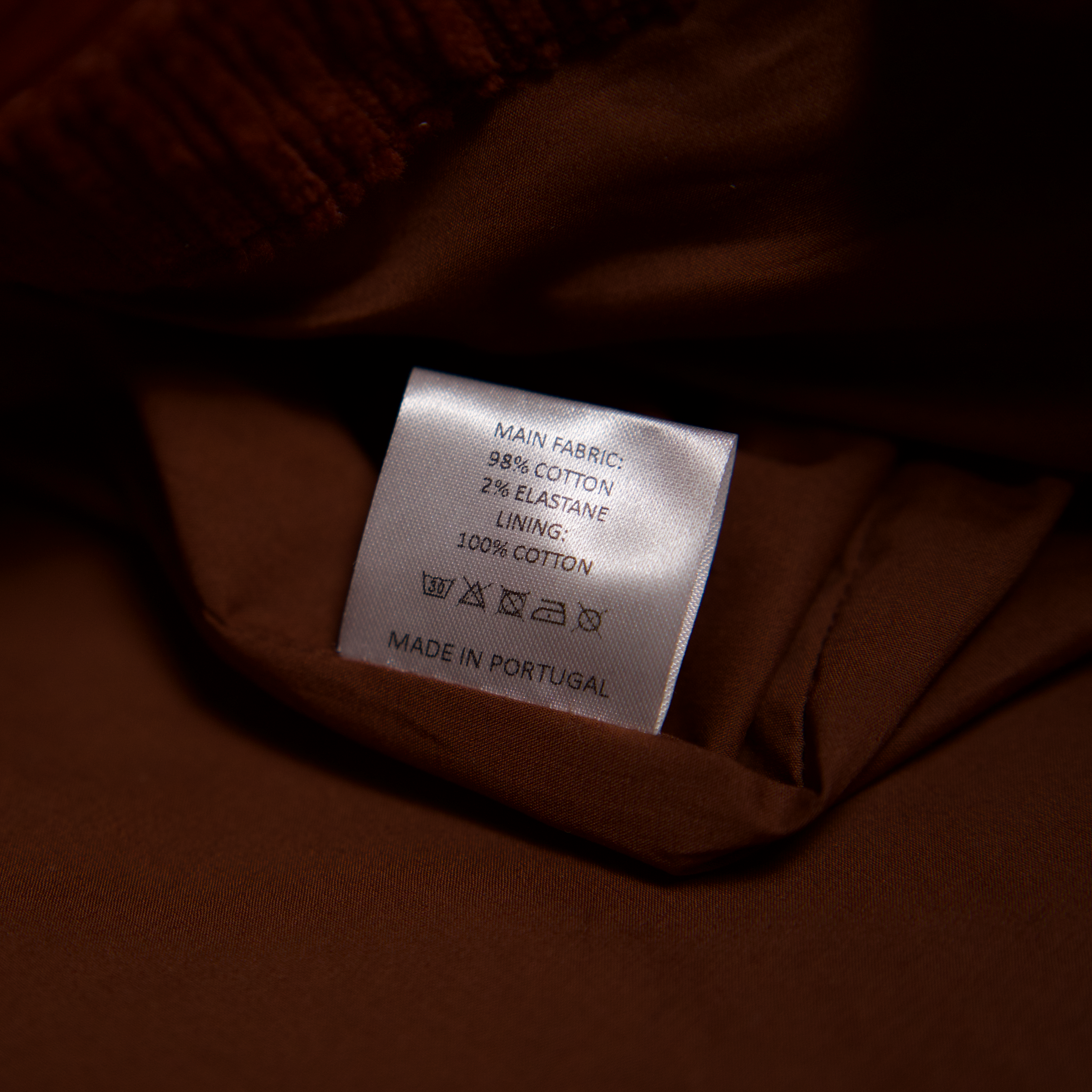 Care label showing fabric composition and made in Portugal