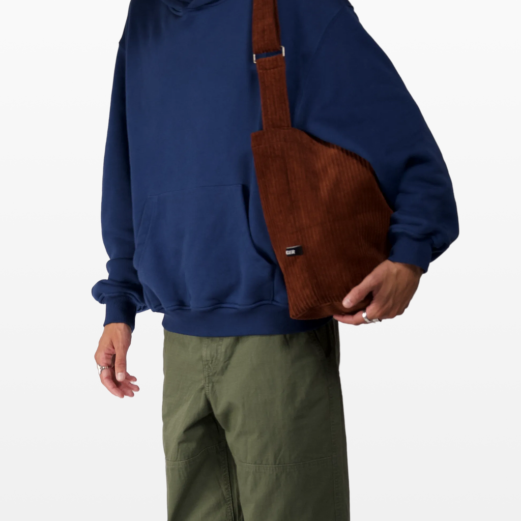 BIRGER rust brown sling bag worn over the shoulder angeled front view